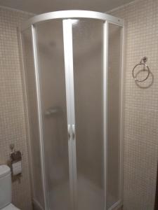 a shower with a glass door in a bathroom at Casa Costeta in Cinctorres