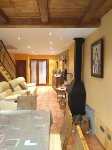 a living room with a wood burning stove in it at Casa Costeta in Cinctorres