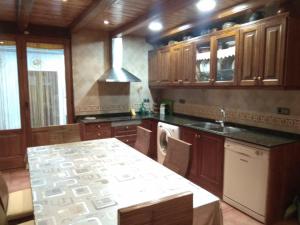 a kitchen with wooden cabinets and a counter top at Casa Costeta in Cinctorres