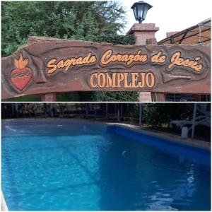 a sign for a swimming pool at a resort at Complejo Sagrado Corazón in Merlo