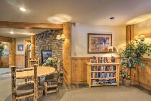 a dining room with a table and a book shelf at Cozy Crested Butte Condo 50 Yards from Ski Lift! in Mount Crested Butte