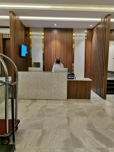 a person taking a picture of a reception desk in a lobby at كيان للأجنحة الفندقية in Khamis Mushayt