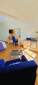 a living room with a blue couch and a table at Hays Suites Hotel in Nairobi