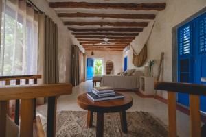 a living room with a couch and a table at Wakax Hacienda - Cenote & Boutique Hotel in Tulum