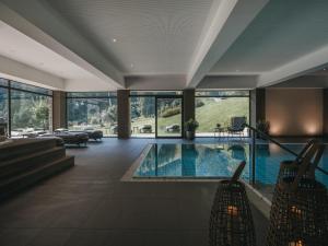 a large house with a swimming pool in a living room at VAYA Zell am See in Zell am See