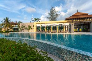 a large swimming pool in front of a building at Ataman Luxury Villas SHA Plus in Ko Kho Khao