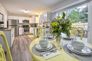a kitchen and dining room with a yellow table and chairs at Charming Southern Pines Abode - Walk to Dtwn! in Southern Pines