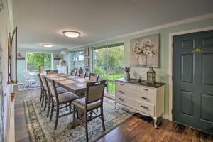 a dining room with a long table and chairs at Spacious Home with Yard, 20 Miles to Olympic NP in Sequim