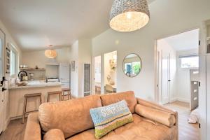 a living room with a couch and a kitchen at Chic and Central Ventura Home - Walk to Beach! in Ventura