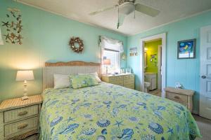a bedroom with a large bed and a bathroom at Peaceful Cottage By The Sea Oceanfront Home! in Surf City