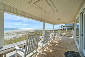 a porch with a row of chairs on the beach at Peaceful Cottage By The Sea Oceanfront Home! in Surf City