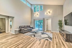a living room with a couch and a table at Remodeled Family Home with Patio - Walk to UF! in Gainesville