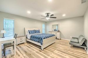 a bedroom with a bed and a ceiling fan at Remodeled Family Home with Patio - Walk to UF! in Gainesville