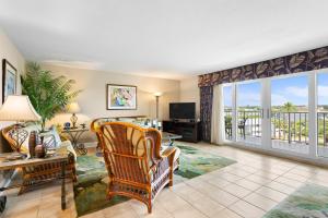 a living room with a view of a balcony at Tropical Paradise in Clearwater Beach