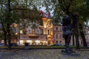 a statue of a woman in front of a building at Chopin Hotel in Lviv