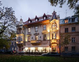 a large white building with lights on it at Chopin Hotel in Lviv