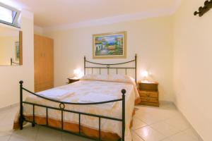 a bedroom with a bed and two night stands at Villa Albarosa in Terradura
