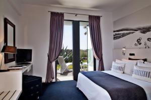 a hotel room with a bed and a sliding glass door at Farol Hotel in Cascais +37 photos