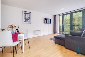 a living room with a couch and a table at City View Apartments Birmingham City Centre in Birmingham