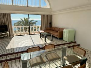 a living room filled with furniture and a large window at Hotel Paraíso Del Mar in Nerja