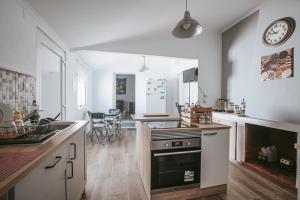 a kitchen with a sink and a stove top oven at Casinha do Roxo in Ervidel