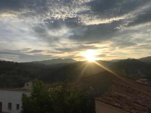 a sunset from the roof of a building with the sun setting at Casa Rural cerca de Morella in Zorita del Maestrazgo