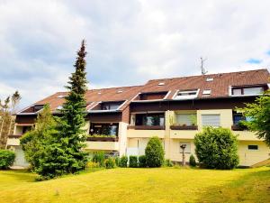 an apartment building with a green yard at Harzbutze 30 in Sankt Andreasberg