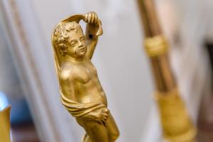 a gold statue of a boy holding his head at Domaine les Crayères in Reims