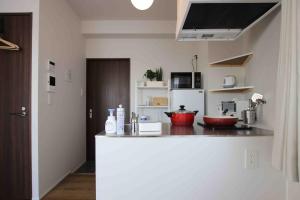 a kitchen with a counter with two bowls on it at Kamatas STAY 京急蒲田駅 徒歩5分 in Tokyo