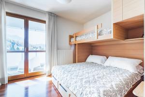 Posteľ alebo postele v izbe v ubytovaní Terrazza su Sestriere Lux