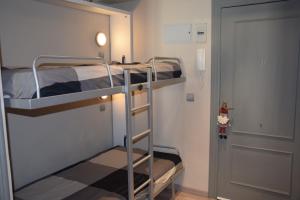a bunk bed room with two bunk beds and a door at IMEDA ESTUDIO DORNAJO in Sierra Nevada