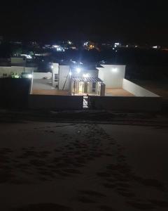 a view of a building at night with lights at Private Sand Bond in Al Raka