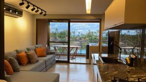 a living room with a couch and a table at Flat Eco resort praia Carneiros PE in Tamandaré