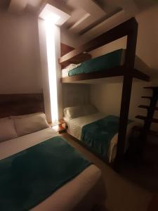 a bedroom with two bunk beds and a window at CIELITO LINDO in Santa Rosa de Cabal