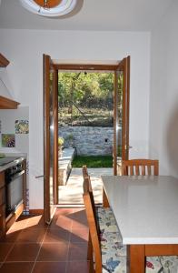 a kitchen with a table and chairs and an open door at Villa Maria in San Feliciano