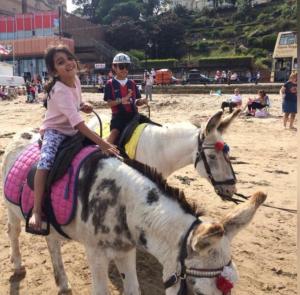 a young girl riding a pony on the beach at Admiral Hotel in Scarborough
