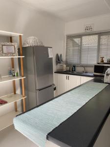 a kitchen with a refrigerator and a counter top at Hillcrest Haven cottage 1 in Hillcrest