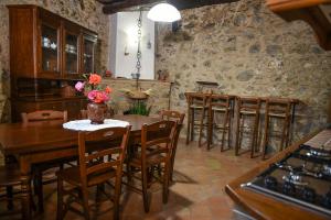 a kitchen with a table and some chairs and a room at Casa Vacanze Nicola e Lina in Tortorella