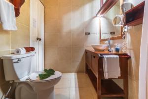 a bathroom with a toilet and a sink at Namuwoki Lodge in Puerto Viejo +133 photos