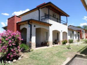 una casa con flores delante en Encanto Puntano en Potrero de los Funes