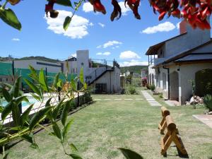 ein Teddybär steht im Hof eines Hauses in der Unterkunft Encanto Puntano in Potrero de los Funes