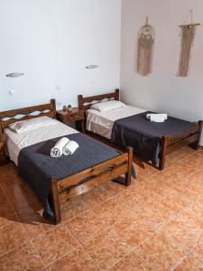 a room with two beds and a table at Kaloudis family in Agios Georgios