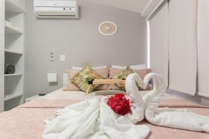- une chambre avec 2 serviettes de cygne sur un lit dans l'établissement Nannai Residence Muro Alto Porto Galinhas BeiraMar, à Porto de Galinhas