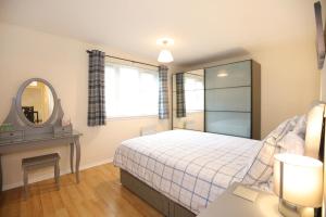 a bedroom with a bed and a mirror at Edinburgh Palace Apartment in Edinburgh
