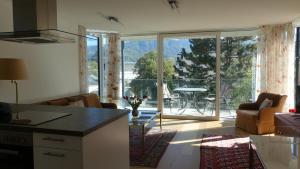 a living room with a large window with a view of a patio at THE VIEW - Modern Panorama Residence in Bad Ischl