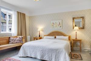 a bedroom with a large bed and a window at Anno 1793 Sekelgården in Ystad
