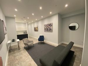 a living room with a couch and a chair at Kempston Suites Liverpool Apartment 2 in Liverpool