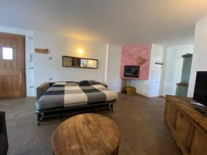 a bedroom with a bed and a wooden table at Chalet dei Reparti Bormio in Bormio