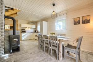 a kitchen and dining room with a wooden table and chairs at Chata Przesieka in Przesieka +27 photos