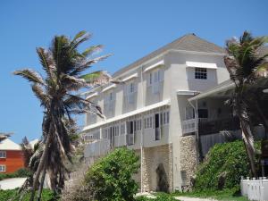 a large white building with palm trees in front of it at The Atlantis Historic Inn in Saint Joseph